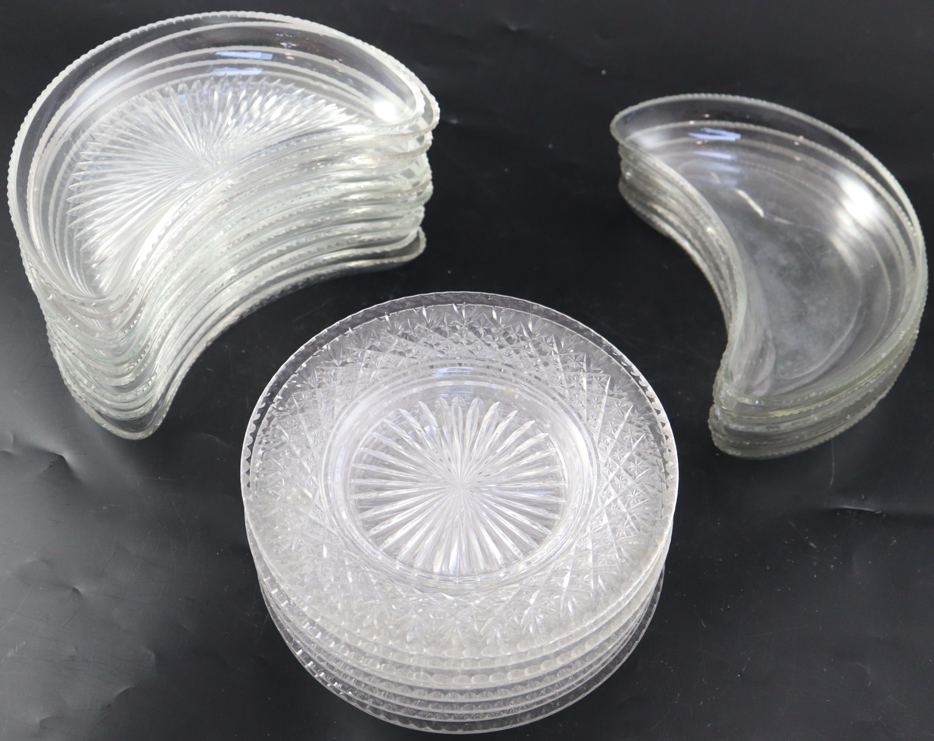 A set of twelve cut glass crescent shaped hors doeuvres dishes,